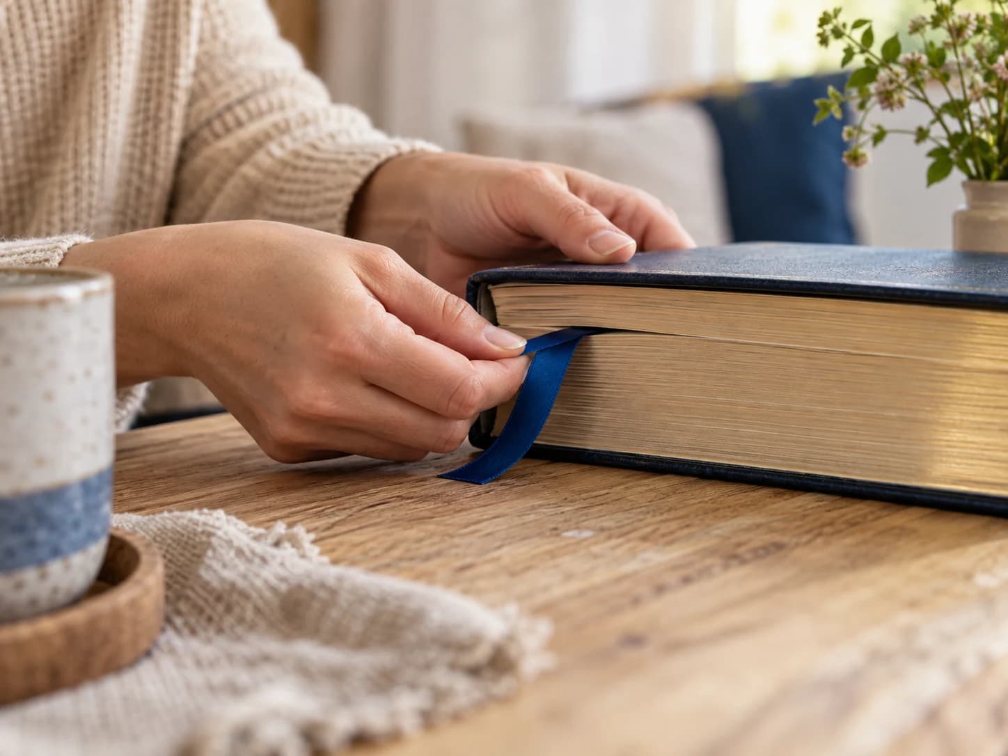 Hands marking a passage with a blue ribbon